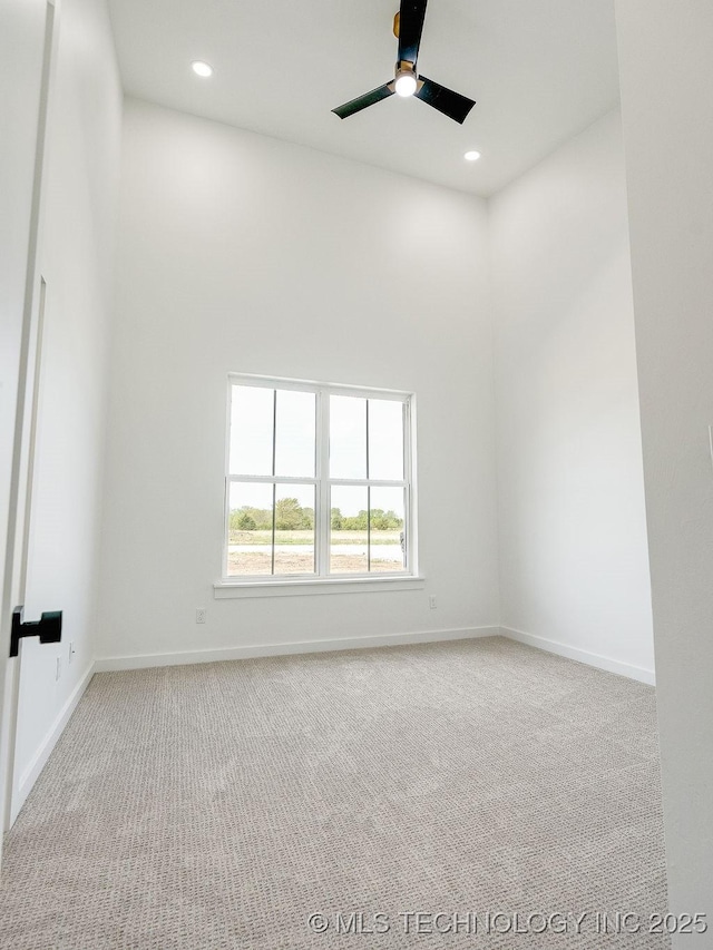 empty room with baseboards, ceiling fan, carpet flooring, and recessed lighting