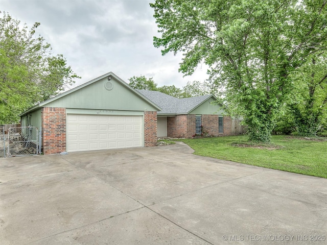 single story home with brick siding, an attached garage, driveway, and a front yard