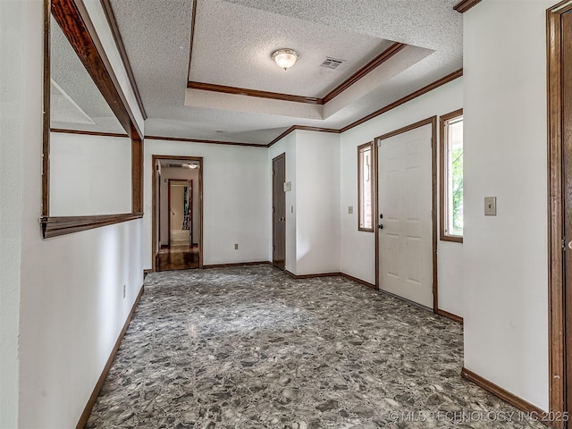 entrance foyer featuring baseboards, ornamental molding, a textured ceiling, and visible vents