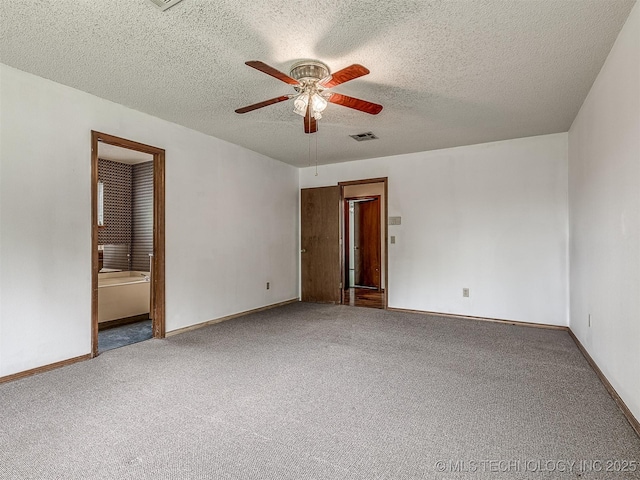 unfurnished room featuring visible vents, a ceiling fan, a textured ceiling, and carpet floors