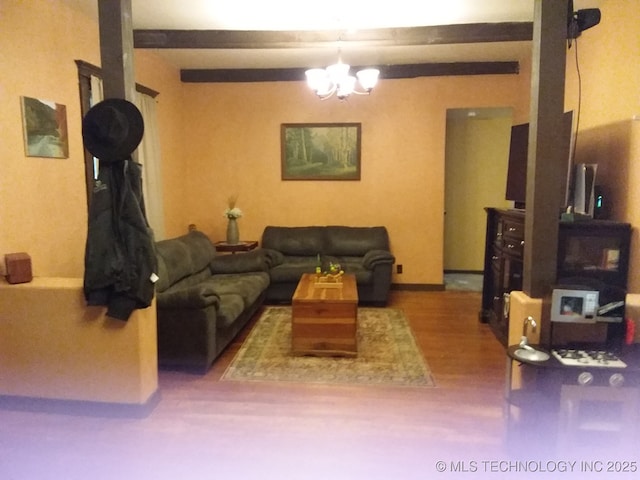 living room with wood finished floors and a notable chandelier