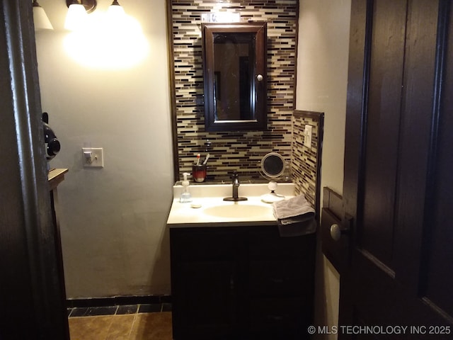 bathroom with tile patterned floors, decorative backsplash, and vanity