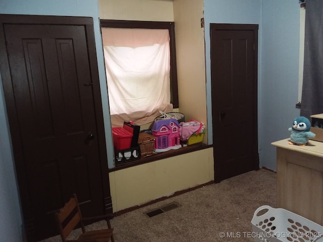carpeted bedroom with visible vents