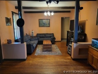 1324 E Hickory St, Okmulgee, OK 74447 - living area with an inviting chandelier, beamed ceiling, and wood finished floors