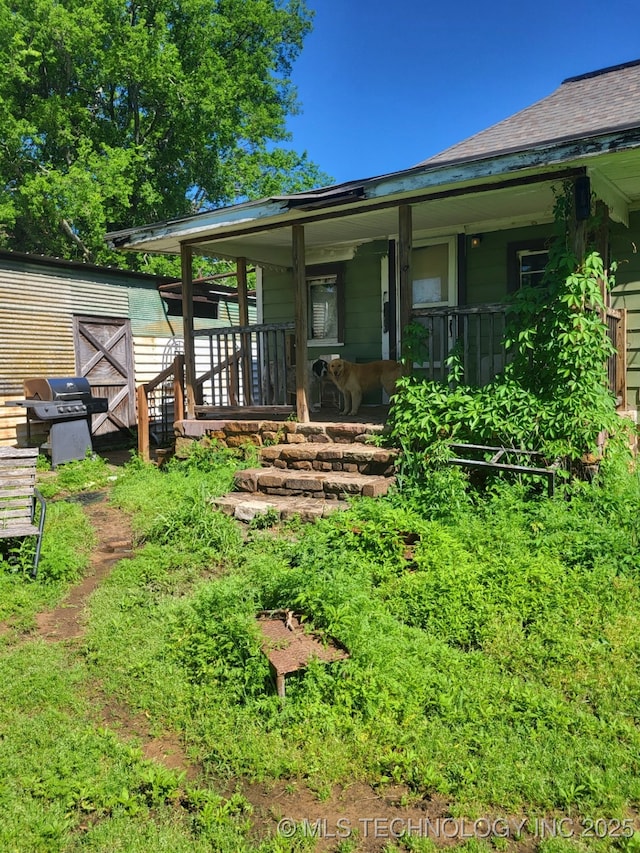 1324 E Hickory St, Okmulgee, OK 74447 - rear view of house featuring covered porch