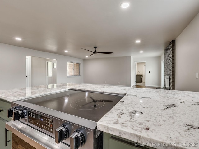 kitchen featuring electric range, open floor plan, recessed lighting, light stone counters, and a ceiling fan
