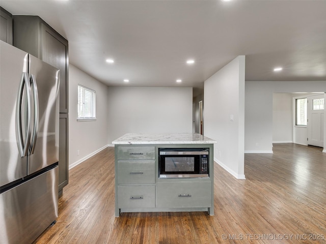 kitchen featuring recessed lighting, baseboards, appliances with stainless steel finishes, and wood finished floors