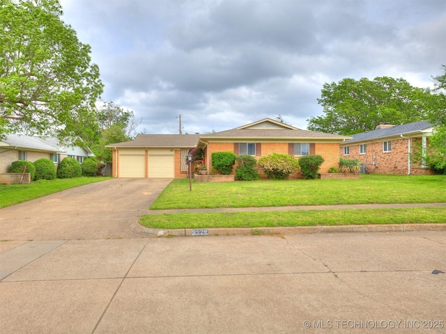 ranch-style home featuring brick siding, an attached garage, driveway, and a front yard