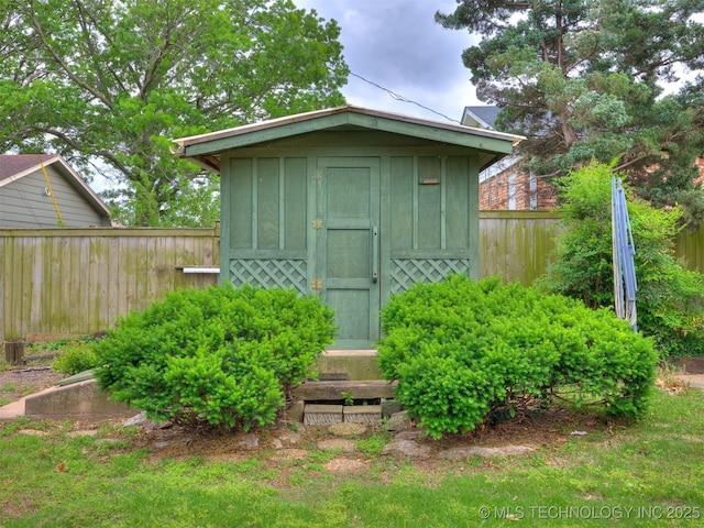 view of shed featuring fence