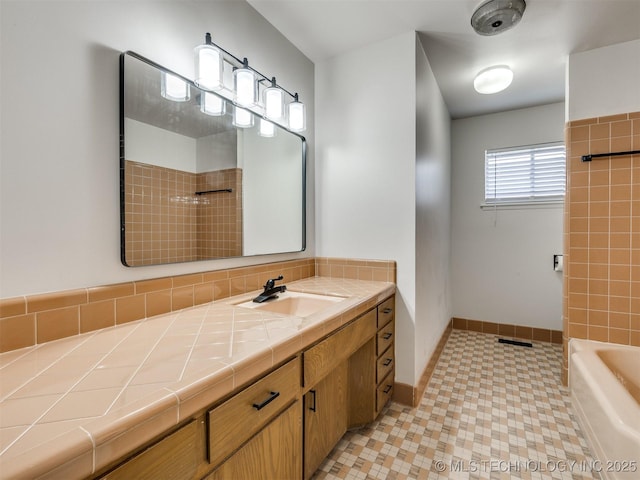 full bath featuring vanity, a bathing tub, baseboards, a shower, and visible vents