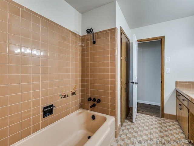 full bathroom with baseboards,  shower combination, tile patterned floors, and vanity