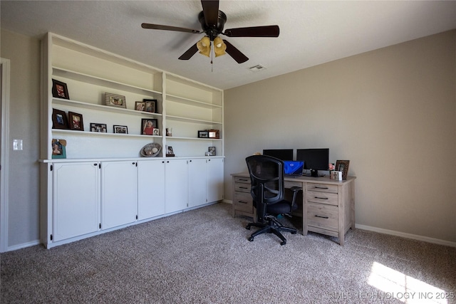 home office featuring visible vents, a ceiling fan, baseboards, and light colored carpet