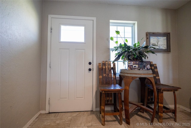 entryway featuring baseboards