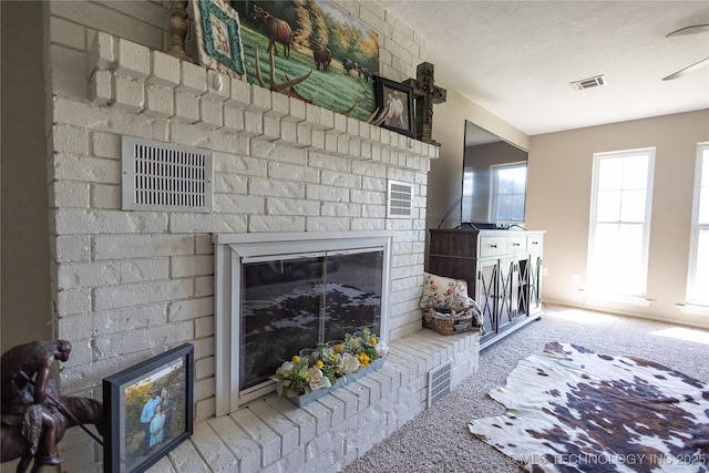 carpeted living area with visible vents, a textured ceiling, and a brick fireplace