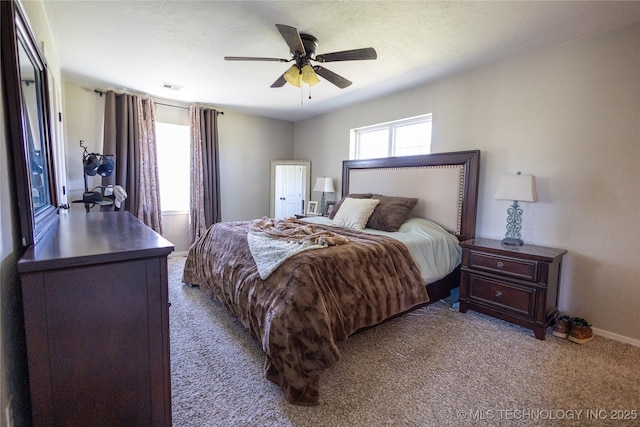 bedroom featuring carpet flooring, a ceiling fan, baseboards, and visible vents