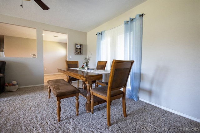 dining room with ceiling fan, a textured ceiling, carpet, baseboards, and lofted ceiling