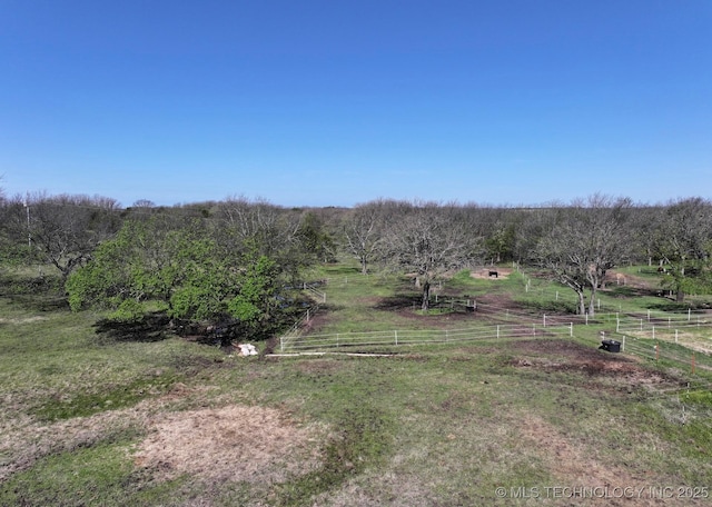 view of yard featuring fence and a rural view