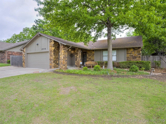 view of front of home featuring fence, an attached garage, stone siding, a front yard, and driveway