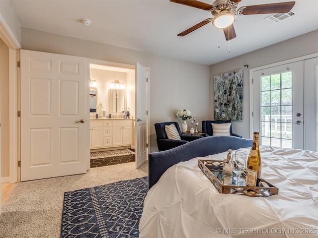bedroom with access to outside, light carpet, a ceiling fan, ensuite bathroom, and visible vents