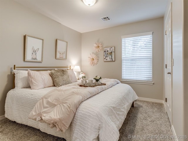 bedroom featuring carpet floors, baseboards, and visible vents