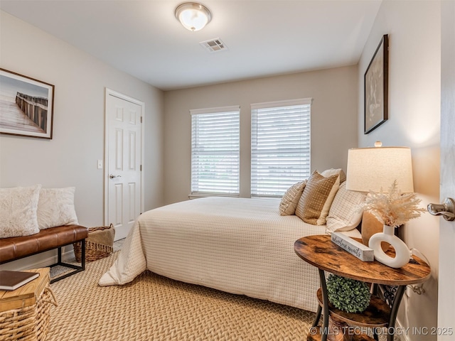 bedroom featuring light carpet and visible vents