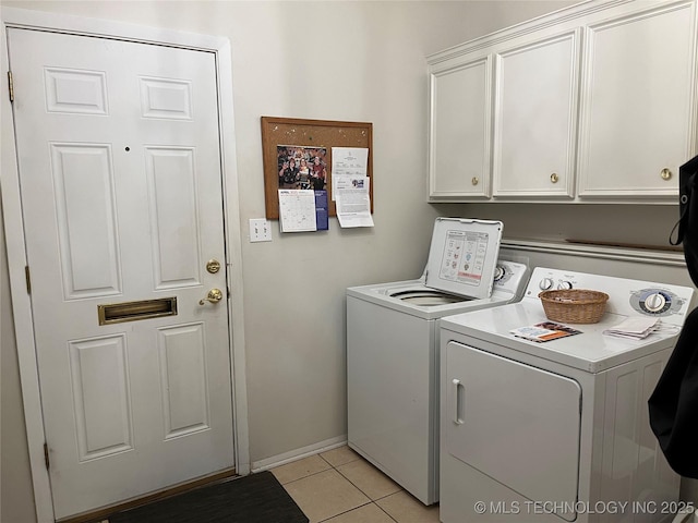 2124 E 60th Ct Unit O-4, Tulsa, OK 74105 - washroom with washer and clothes dryer, cabinet space, and light tile patterned floors