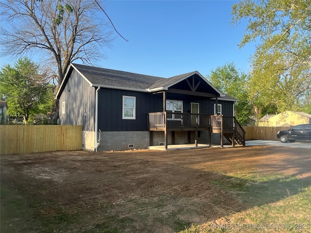 5114 W 3rd St, Tulsa, OK 74127 - view of front of home with fence, stairs, and a wooden deck