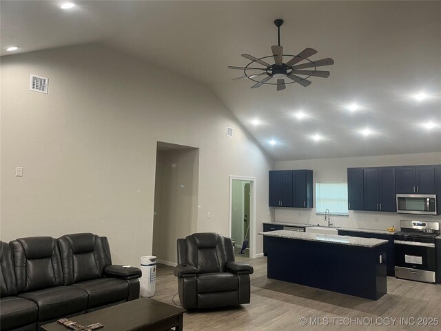 5114 W 3rd St, Tulsa, OK 74127 - living area with a ceiling fan, visible vents, high vaulted ceiling, baseboards, and light wood-style flooring