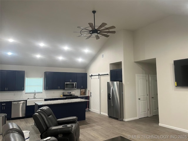 5114 W 3rd St, Tulsa, OK 74127 - kitchen featuring a ceiling fan, a center island, wood finished floors, a sink, and stainless steel appliances