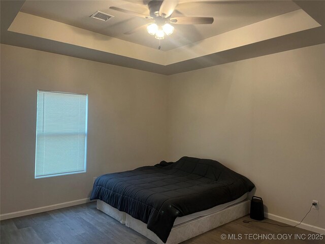 5114 W 3rd St, Tulsa, OK 74127 - bedroom with baseboards, visible vents, wood finished floors, and a raised ceiling