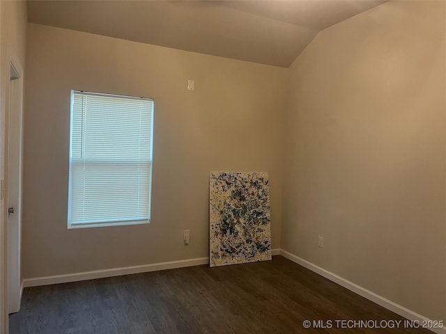 5114 W 3rd St, Tulsa, OK 74127 - spare room featuring baseboards, vaulted ceiling, and dark wood-style floors