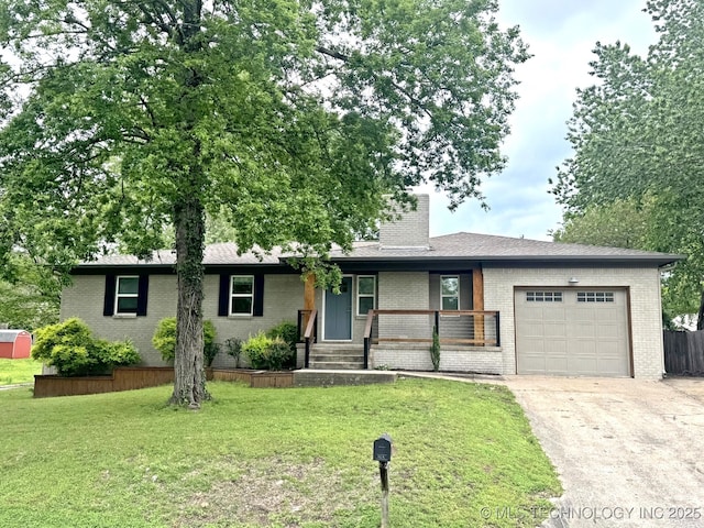 single story home featuring covered porch, a front yard, brick siding, concrete driveway, and an attached garage