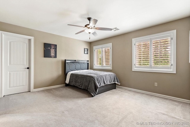 bedroom with carpet flooring, baseboards, visible vents, and ceiling fan