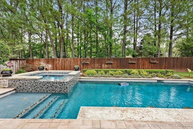 view of swimming pool with fence, an in ground hot tub, and a fenced in pool