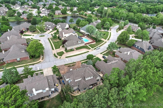 bird's eye view featuring a residential view and a water view