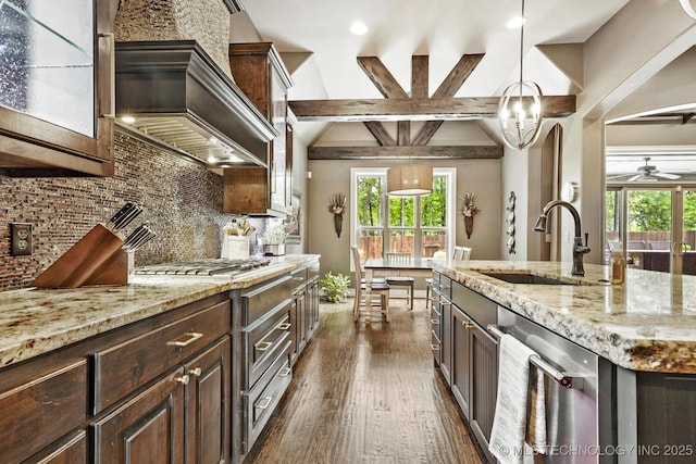 kitchen featuring dark brown cabinets, appliances with stainless steel finishes, a sink, and dark wood finished floors