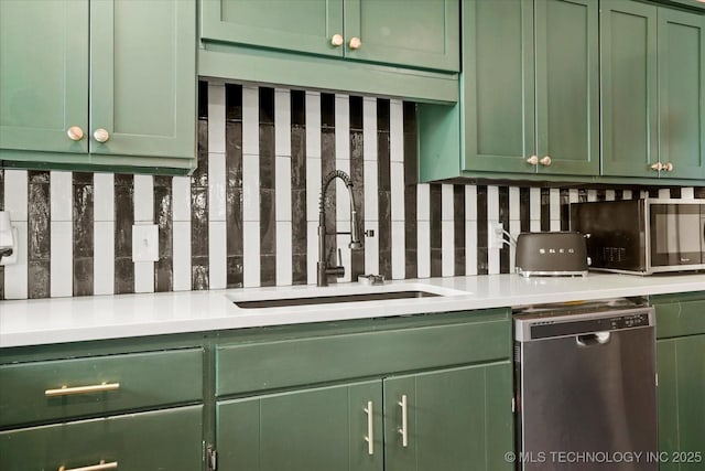 5729 E 25th Pl, Tulsa, OK 74114 - kitchen featuring light countertops, tasteful backsplash, a sink, green cabinets, and stainless steel appliances