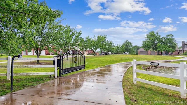 surrounding community with a gate, a fenced front yard, and a yard