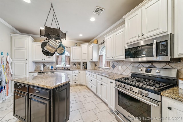 kitchen featuring visible vents, ornamental molding, white cabinets, and stainless steel appliances