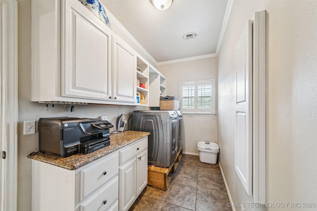 washroom featuring visible vents, cabinet space, baseboards, separate washer and dryer, and ornamental molding