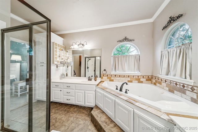 bathroom featuring vanity, ornamental molding, a stall shower, and a garden tub