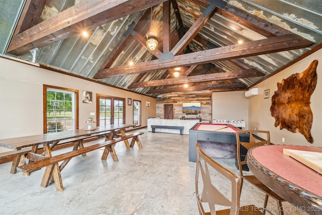 playroom with high vaulted ceiling and finished concrete floors