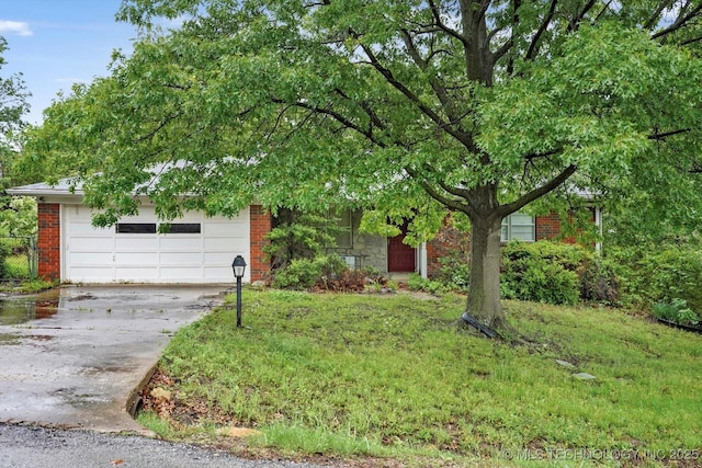 obstructed view of property with brick siding and driveway