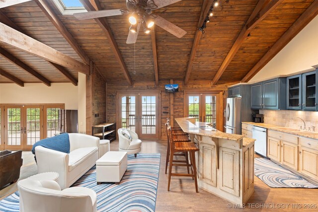53402 E 332nd Loop, Jay, OK 74346 - living area featuring french doors, wooden ceiling, a ceiling fan, light wood-type flooring, and a skylight