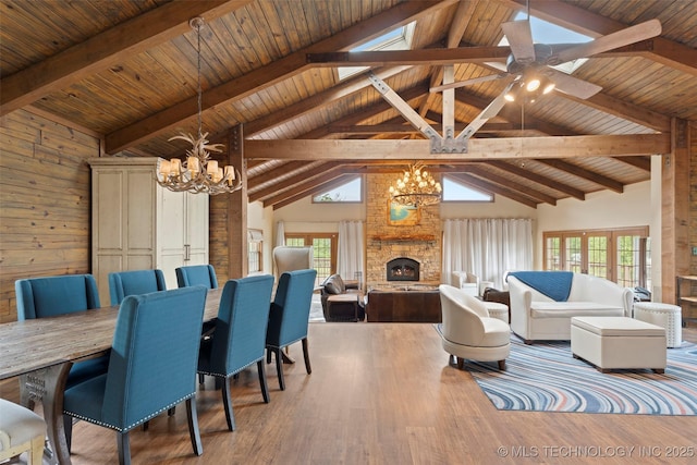 53402 E 332nd Loop, Jay, OK 74346 - dining space featuring a chandelier, high vaulted ceiling, a stone fireplace, wood ceiling with exposed beams, and wood finished floors
