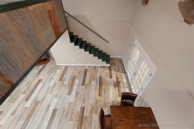 staircase with baseboards and wood finished floors