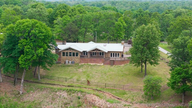 drone / aerial view featuring a wooded view
