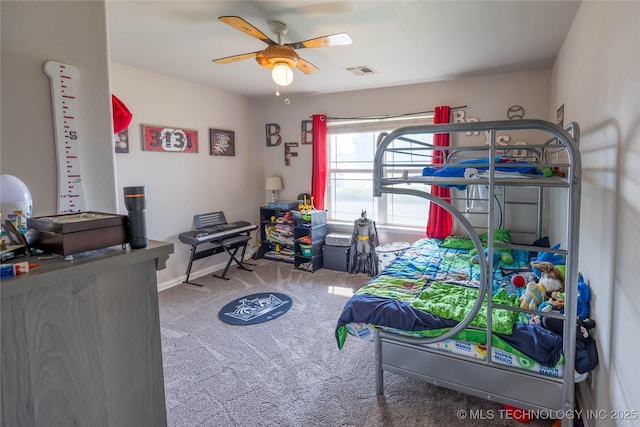 carpeted bedroom with visible vents, baseboards, and ceiling fan