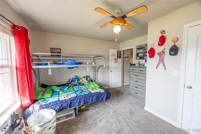bedroom featuring carpet floors, baseboards, and multiple windows