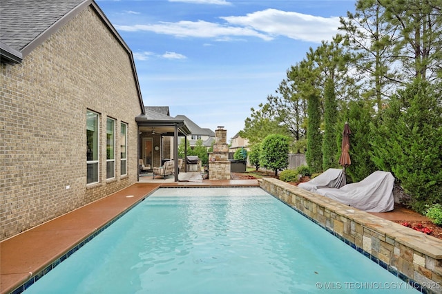 view of pool with a fenced in pool, a patio area, and fence